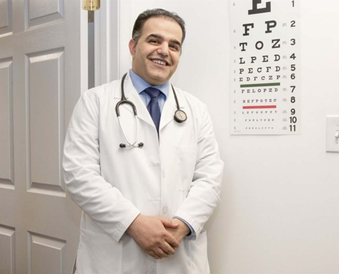 Dr. Ahmad Ziaie standing in an exam room at US Primary and Urgent Care
