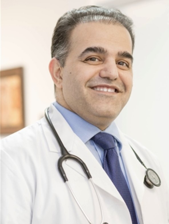 Dr. Ahmad Ziaie, MD, smiling in a white coat with a stethoscope